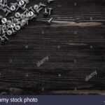 Some Wood Crews On Dark Wooden Desk Board Surface. Top View For Borderless Certificate Templates