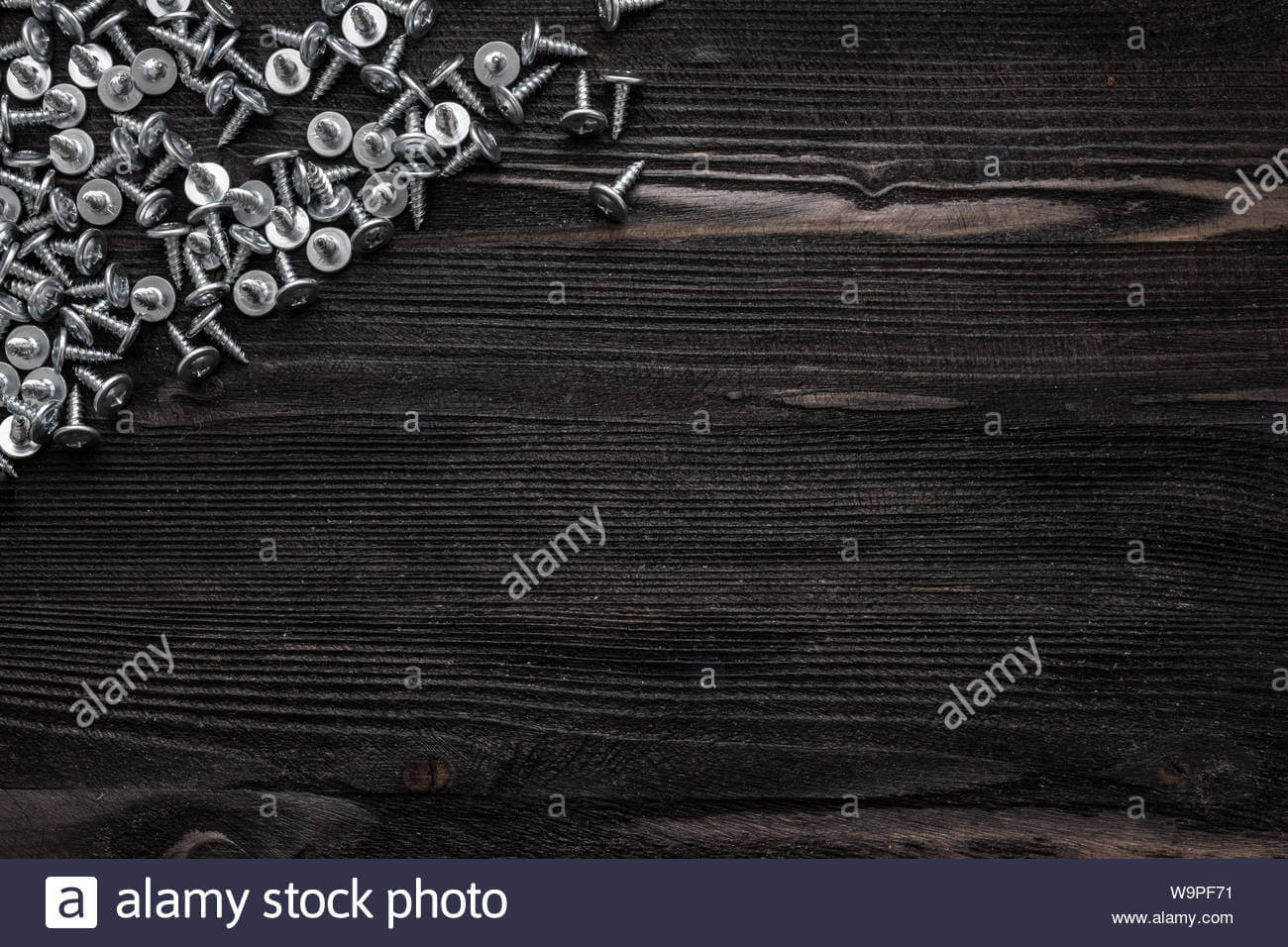 Some Wood Crews On Dark Wooden Desk Board Surface. Top View For Borderless Certificate Templates